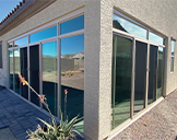 Bright Patio Enclosures sunroom with floor-to-ceiling windows, creating a comfortable space to enjoy outdoor views year-round.