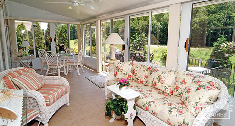 Sunroom Decorated with White Wicker Furniture and Pastel Fabric