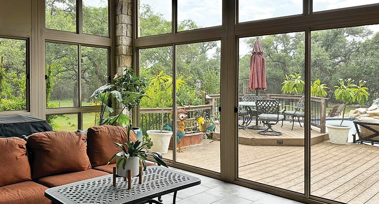 Virtually invisible screened walls of a patio enclosure provide guard against bugs but allow views of the deck and backyard.

