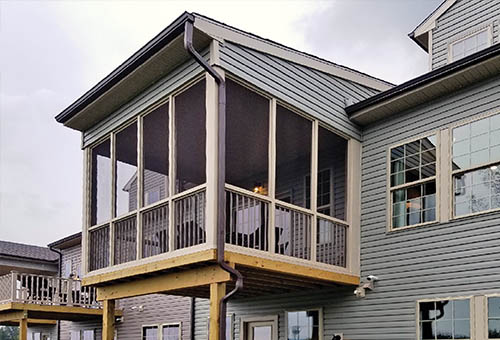 Outside View of a Sunroom Under Existing Roof on the Front of a House