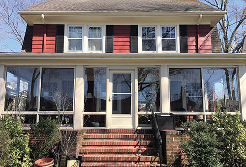 Outside View of a Large Sunroom Under Existing Roof As Part of a Deck