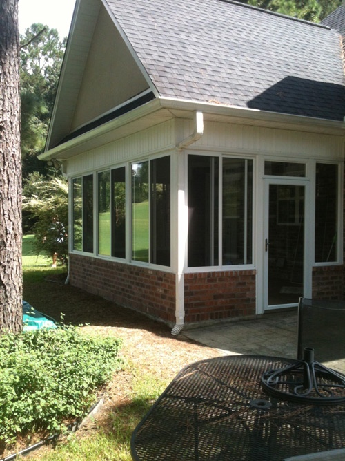 Outside View Of A Sunroom With Vaulted Ceiling and Brick