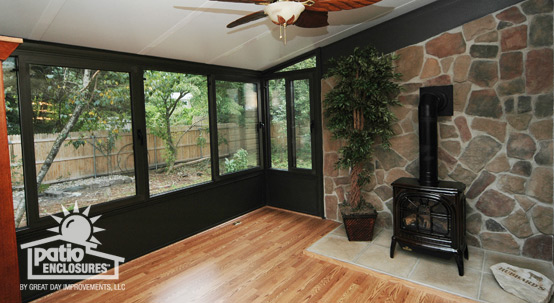 Vented stovepipe fireplace against a natural stone wall