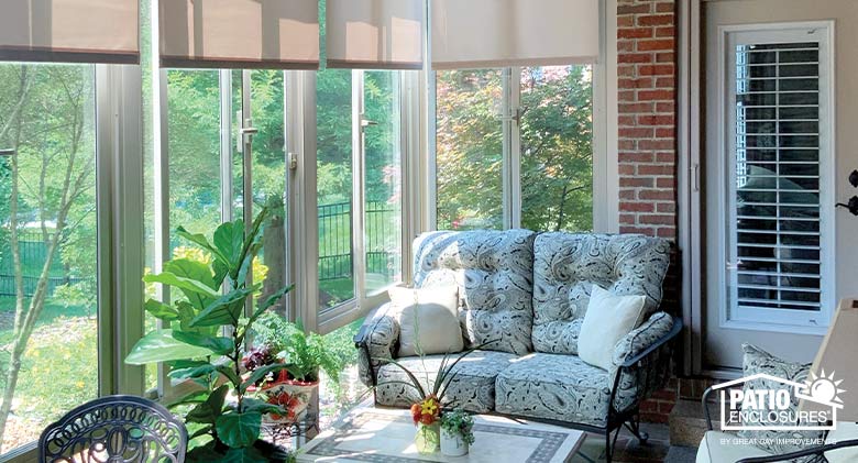 Patio Enclosures sunroom with cozy loveseat