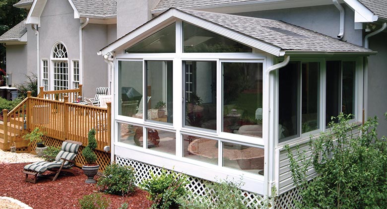 A glass roof panel provides additional light in this year-round four-season room with a gable roof.