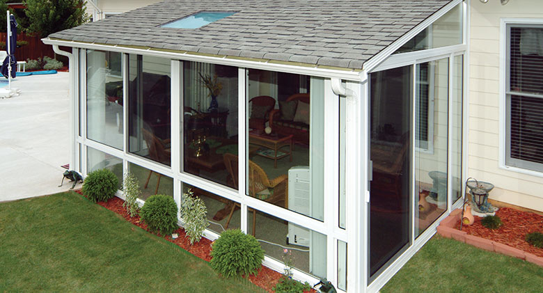 A cozy Elite three-season room with single-slope roof and a glass roof panel is a great family space.