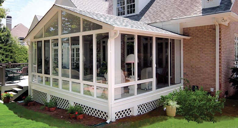 An Elite three-season room with gable roof and deck access is a great entertaining space.