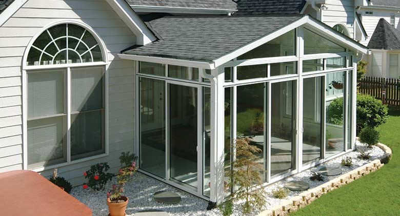 An Elite three-season room with glass wings in a gable roof is light and bright.