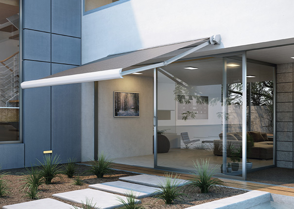 liding glass door entry to a modern home protected by a retractable awnin
